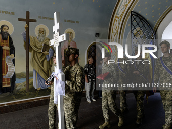 Servicemen are carrying the coffin of Captain Arsen Fedosenko, a photographer for the Media Center of the Ukrainian Armed Forces Strategic C...