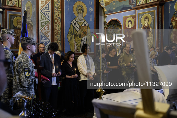 People are attending a funeral service for Captain Arsen Fedosenko, a photographer for the Media Center of the Ukrainian Armed Forces Strate...