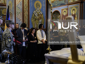 People are attending a funeral service for Captain Arsen Fedosenko, a photographer for the Media Center of the Ukrainian Armed Forces Strate...