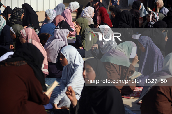 Palestinian women are reciting from memory the entire Koran, Islam's holy book, in one sitting at a camp for displaced people in Deir el-Bal...