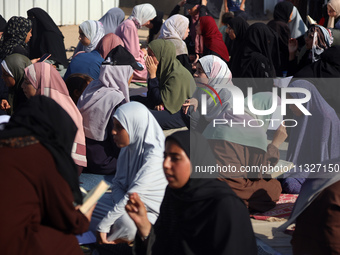 Palestinian women are reciting from memory the entire Koran, Islam's holy book, in one sitting at a camp for displaced people in Deir el-Bal...