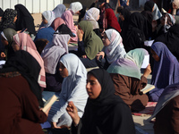 Palestinian women are reciting from memory the entire Koran, Islam's holy book, in one sitting at a camp for displaced people in Deir el-Bal...