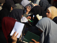 Palestinian women are reciting from memory the entire Koran, Islam's holy book, in one sitting at a camp for displaced people in Deir el-Bal...