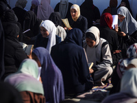 Palestinian women are reciting from memory the entire Koran, Islam's holy book, in one sitting at a camp for displaced people in Deir el-Bal...