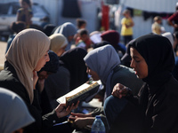 Palestinian women are reciting from memory the entire Koran, Islam's holy book, in one sitting at a camp for displaced people in Deir el-Bal...