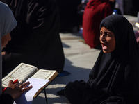 Palestinian women are reciting from memory the entire Koran, Islam's holy book, in one sitting at a camp for displaced people in Deir el-Bal...