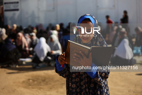 Palestinian women are reciting from memory the entire Koran, Islam's holy book, in one sitting at a camp for displaced people in Deir el-Bal...