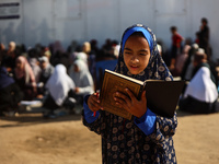 Palestinian women are reciting from memory the entire Koran, Islam's holy book, in one sitting at a camp for displaced people in Deir el-Bal...