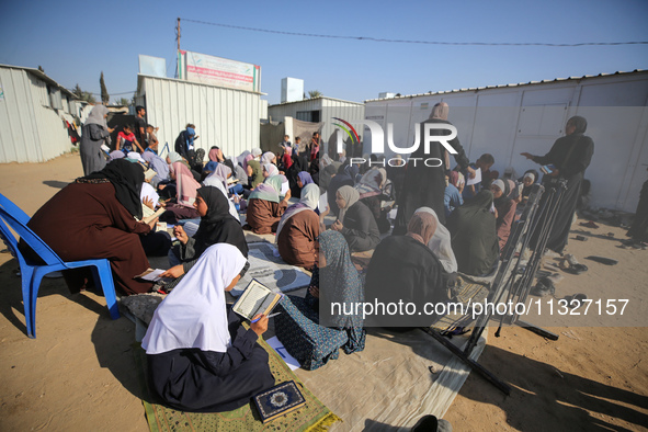 Palestinian women are reciting from memory the entire Koran, Islam's holy book, in one sitting at a camp for displaced people in Deir el-Bal...