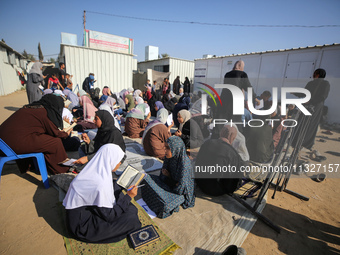 Palestinian women are reciting from memory the entire Koran, Islam's holy book, in one sitting at a camp for displaced people in Deir el-Bal...