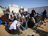 Palestinian women are reciting from memory the entire Koran, Islam's holy book, in one sitting at a camp for displaced people in Deir el-Bal...