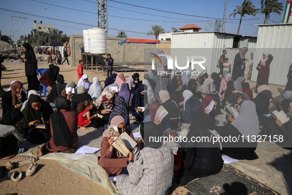 Palestinian women are reciting from memory the entire Koran, Islam's holy book, in one sitting at a camp for displaced people in Deir el-Bal...