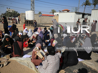 Palestinian women are reciting from memory the entire Koran, Islam's holy book, in one sitting at a camp for displaced people in Deir el-Bal...