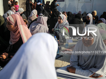 Palestinian women are reciting from memory the entire Koran, Islam's holy book, in one sitting at a camp for displaced people in Deir el-Bal...