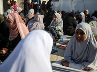 Palestinian women are reciting from memory the entire Koran, Islam's holy book, in one sitting at a camp for displaced people in Deir el-Bal...