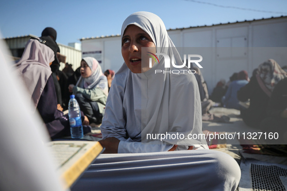 Palestinian women are reciting from memory the entire Koran, Islam's holy book, in one sitting at a camp for displaced people in Deir el-Bal...