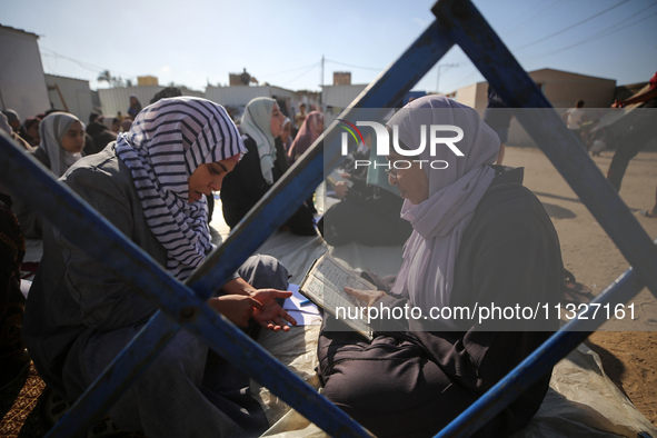 Palestinian women are reciting from memory the entire Koran, Islam's holy book, in one sitting at a camp for displaced people in Deir el-Bal...