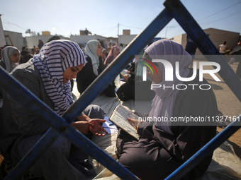 Palestinian women are reciting from memory the entire Koran, Islam's holy book, in one sitting at a camp for displaced people in Deir el-Bal...