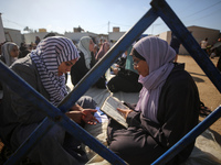 Palestinian women are reciting from memory the entire Koran, Islam's holy book, in one sitting at a camp for displaced people in Deir el-Bal...