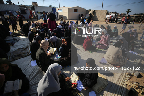 Palestinian women are reciting from memory the entire Koran, Islam's holy book, in one sitting at a camp for displaced people in Deir el-Bal...