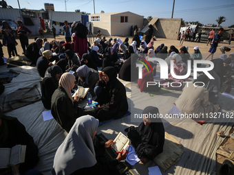 Palestinian women are reciting from memory the entire Koran, Islam's holy book, in one sitting at a camp for displaced people in Deir el-Bal...