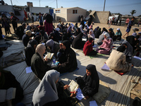 Palestinian women are reciting from memory the entire Koran, Islam's holy book, in one sitting at a camp for displaced people in Deir el-Bal...