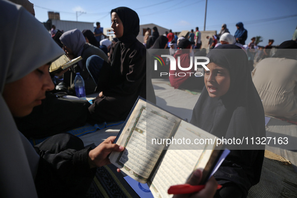 Palestinian women are reciting from memory the entire Koran, Islam's holy book, in one sitting at a camp for displaced people in Deir el-Bal...