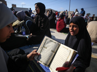 Palestinian women are reciting from memory the entire Koran, Islam's holy book, in one sitting at a camp for displaced people in Deir el-Bal...