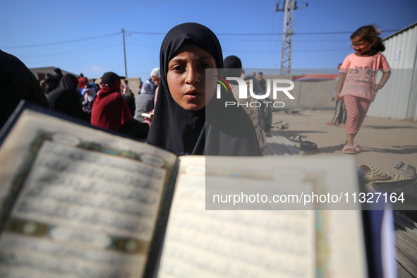 Palestinian women are reciting from memory the entire Koran, Islam's holy book, in one sitting at a camp for displaced people in Deir el-Bal...