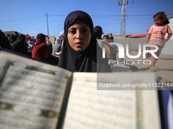 Palestinian women are reciting from memory the entire Koran, Islam's holy book, in one sitting at a camp for displaced people in Deir el-Bal...