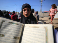 Palestinian women are reciting from memory the entire Koran, Islam's holy book, in one sitting at a camp for displaced people in Deir el-Bal...