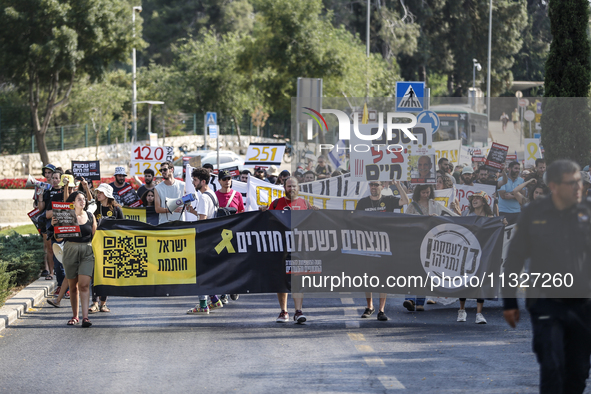 Students holding images of kidnapped Israelis rally, calling on the Israeli government to stop the war in Gaza and bring back the hostages,...