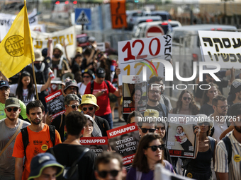 Students holding images of kidnapped Israelis rally, calling on the Israeli government to stop the war in Gaza and bring back the hostages,...