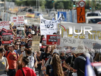 Students holding images of kidnapped Israelis rally, calling on the Israeli government to stop the war in Gaza and bring back the hostages,...