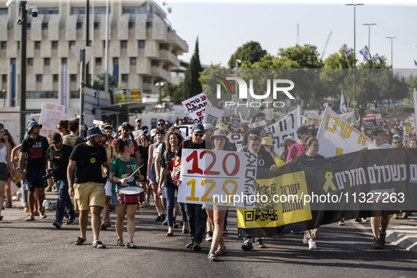 Students holding images of kidnapped Israelis rally, calling on the Israeli government to stop the war in Gaza and bring back the hostages,...