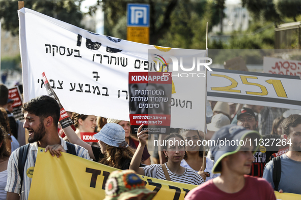 Students holding images of kidnapped Israelis rally, calling on the Israeli government to stop the war in Gaza and bring back the hostages,...