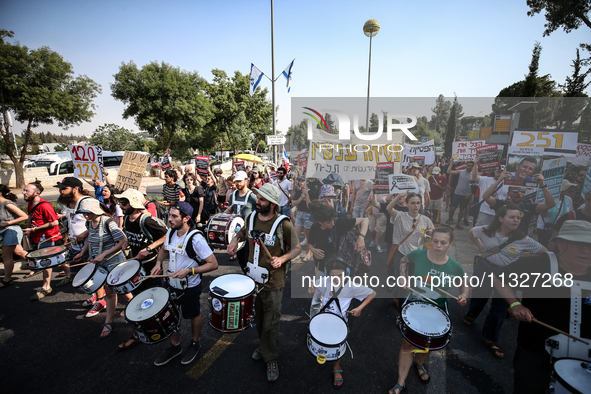 Students holding images of kidnapped Israelis rally, calling on the Israeli government to stop the war in Gaza and bring back the hostages,...