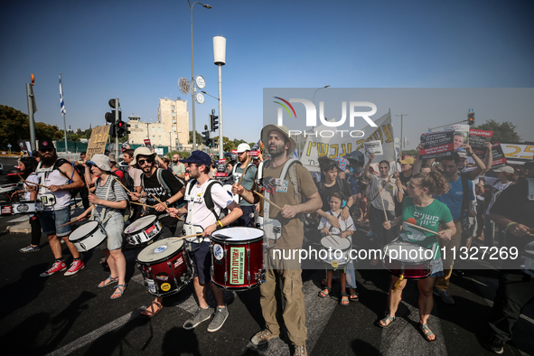 Students holding images of kidnapped Israelis rally, calling on the Israeli government to stop the war in Gaza and bring back the hostages,...