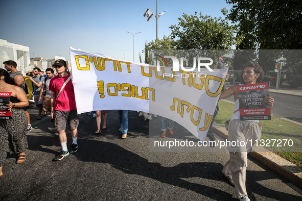 Students holding images of kidnapped Israelis rally, calling on the Israeli government to stop the war in Gaza and bring back the hostages,...