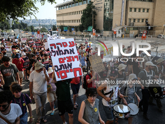 Students holding images of kidnapped Israelis rally, calling on the Israeli government to stop the war in Gaza and bring back the hostages,...