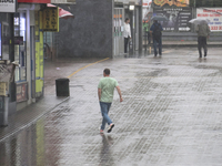 A man is running under heavy rain, which is amounting to half of the monthly average, in Kyiv, Ukraine, on June 12, 2024. NO USE RUSSIA. NO...