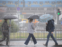 Pedestrians are walking under umbrellas during heavy rain, which is amounting to half of the monthly average, in Kyiv, Ukraine, on June 12,...