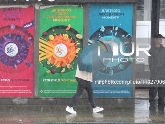 A woman is walking under an umbrella during heavy rain, which is amounting to half of the monthly average, in Kyiv, Ukraine, on June 12, 202...