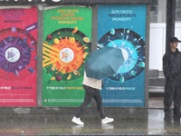 A woman is walking under an umbrella during heavy rain, which is amounting to half of the monthly average, in Kyiv, Ukraine, on June 12, 202...