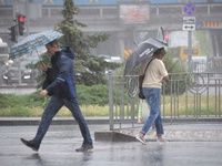 Pedestrians are walking under umbrellas during heavy rain, which is amounting to half of the monthly average, in Kyiv, Ukraine, on June 12,...