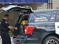 The Elmhurst Police are taking evidence out of US Bank. An armed bank robbery is occurring at US Bank in Elmhurst, Illinois, United States,...