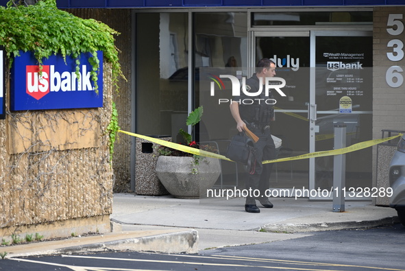 The Elmhurst Police are taking evidence out of US Bank. An armed bank robbery is occurring at US Bank in Elmhurst, Illinois, United States,...