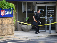 The Elmhurst Police are taking evidence out of US Bank. An armed bank robbery is occurring at US Bank in Elmhurst, Illinois, United States,...