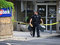 The Elmhurst Police are taking evidence out of US Bank. An armed bank robbery is occurring at US Bank in Elmhurst, Illinois, United States,...