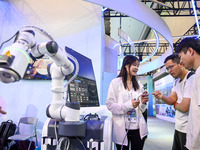 Visitors are visiting an ultrasound therapy robot at The 10th China (Shanghai) International Technology Fair in Shanghai, China, on June 13,...